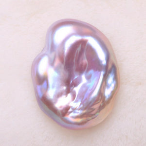 Iridescent pearl on a light beige background